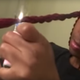 A YouTube vlogger demonstrates how to seal your synthetic braids with a lighter.